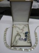 A necklace, bracelet, brooch set and a necklace, bracelet and earrings set.