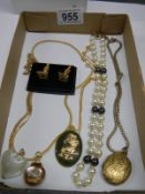 A selection of necklaces including a jade dragon pendant.