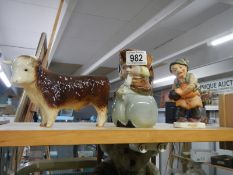 A ceramic bull, Toby jug and figure.
