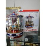 A boxed Mr Christmas musical metallic holiday go round, plays 50 Christmas and all year tunes,
