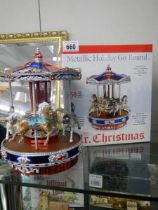 A boxed Mr Christmas musical metallic holiday go round, plays 50 Christmas and all year tunes,