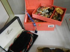 A jewellery box with costume jewellery including cased Lotus multi-coloured necklace.