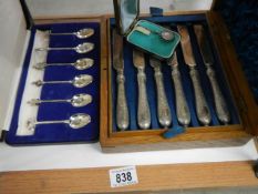 A cased set of knives and forks (missing 2 forks) and a cased set of spoons.