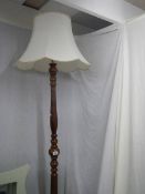 A turned wood standard lamp. COLLECT ONLY.