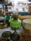 A Victorian oil lamp with green glass font, COLLECT ONLY.