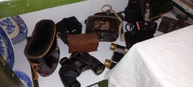A quantity of binoculars and cameras including polaroid, kodak, brownie etc