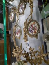 A pair of brass wall ornaments with porcelain plaques, COLLECT ONLY.