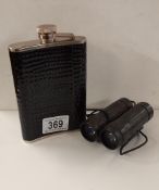 A hip flask and compact binoculars