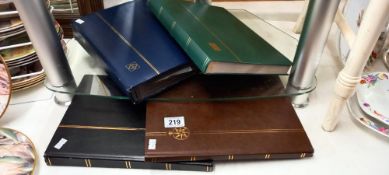 4 stamp albums with world wide stamps etc