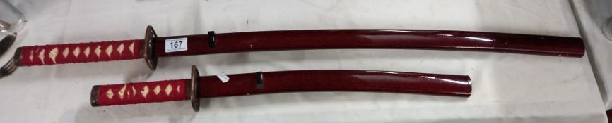 A 2 piece replica Samurai sword set in lacquered red high gloss finish (Katana and Wakizashi)