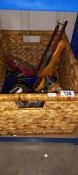 A raffia box containing a quantity of shoe cleaning brushes/polishes and clothing brushes etc