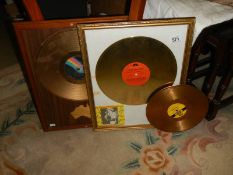 Two framed Hank Williams gold discs and one unframed, COLLECT ONLY.