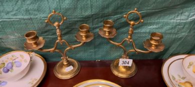 A pair of small brass candlesticks