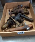 A tray of brass and wooden vintage taps