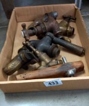 A tray of brass and wooden vintage taps