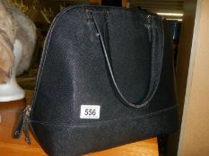 A black faux leather hand bag.