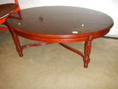 An oval mahogany coffee table, COLLECT ONLY.