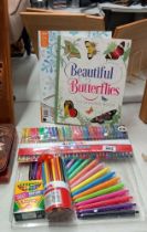A selection of colouring pens, pencils and crayons plus 2 colouring books