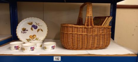 A wicker basket with glass and silver plate coasters plus placemats and Royal Worcester Evesham ware