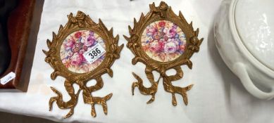 2 brass wall hangings with porcelain inserts