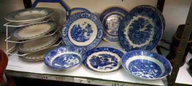 A shelf of early 20c onwards blue and white plates etc