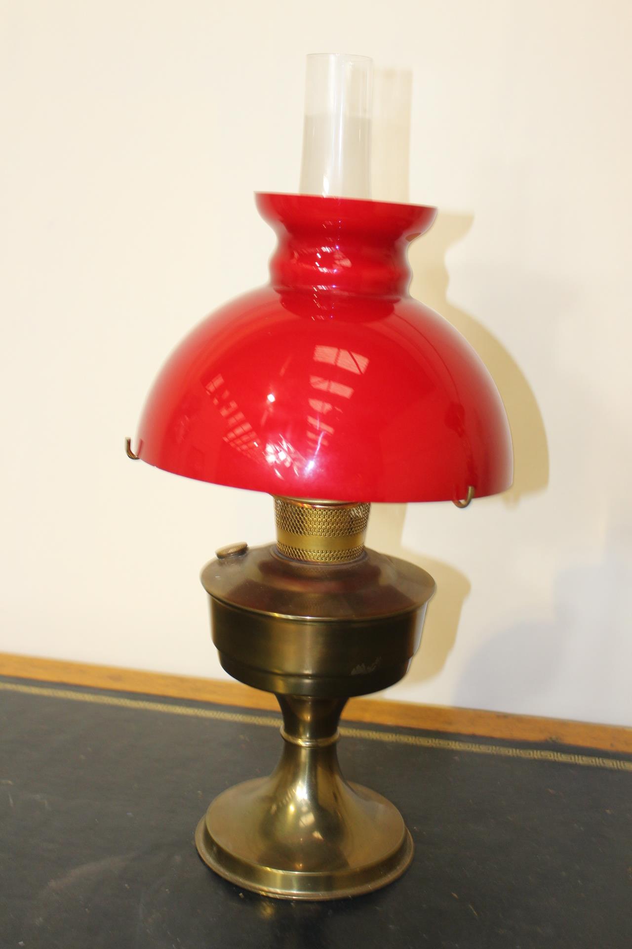 Brass oil lamp with red glass shade {55 cm H x 24 cm Dia.}.