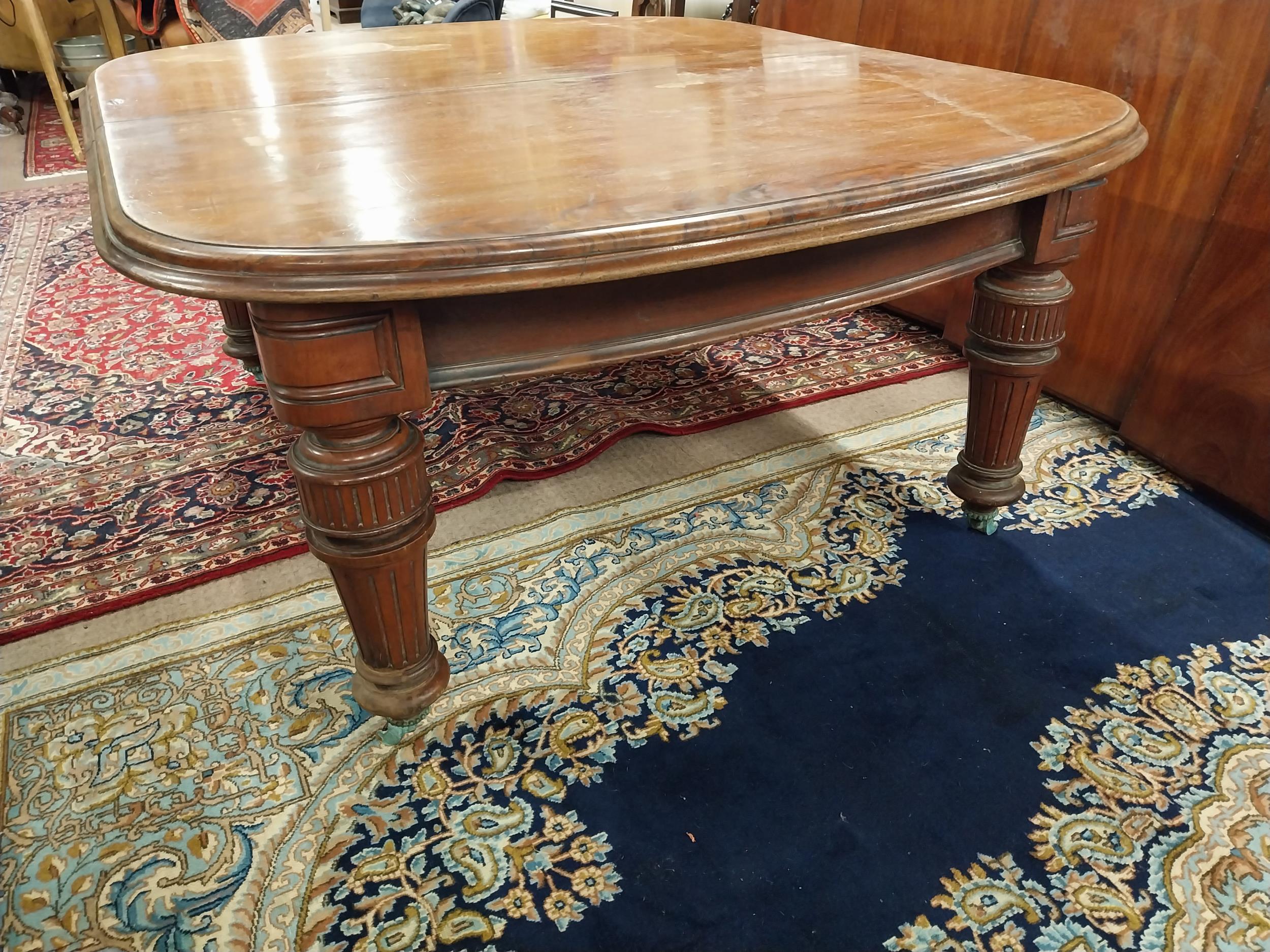 19th C. mahogany extension dining table with four extra leaves on reeded legs and brass castors { - Image 3 of 4