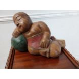 Carved hardwood model of a sleeping Buddha {24 cm H x 36 cm W x 17 cm D}.