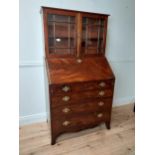 Georgian mahogany bureau bookcase with two glazed panel doors above four graduated drawers and