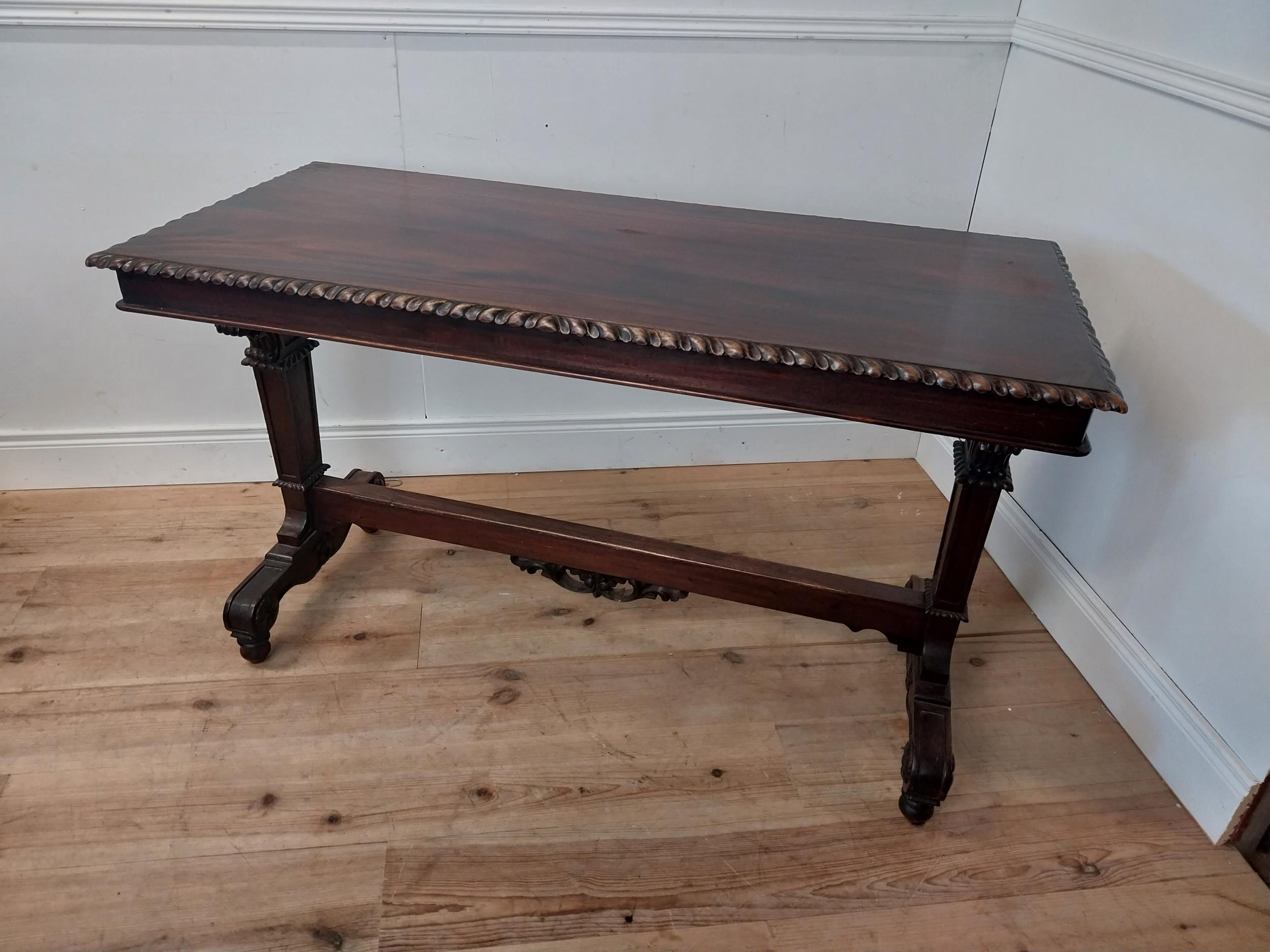 Mahogany library table in the William IV manner on carved columns and platform base {78cm H x