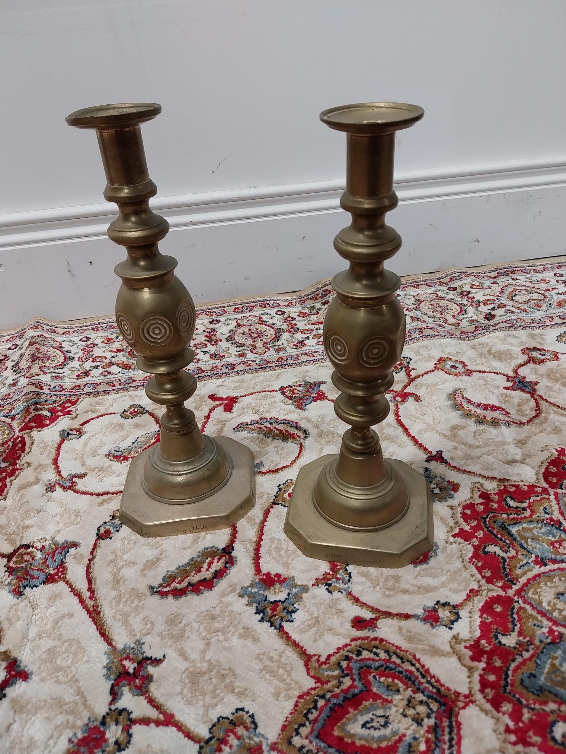 Pair of brass candlesticks {29 cm H x 10 cm W x 10 cm D}.