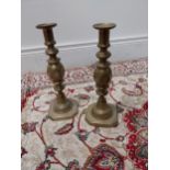 Pair of brass candlesticks {29 cm H x 10 cm W x 10 cm D}.