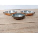 Set of three graduated copper and brass dishes {5 cm H x 18 cm W x 12 cm D to 4 cm H x 22 cm W x