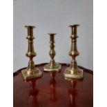 Three 19th C. brass candlesticks {21 cm & 19 cm H}.