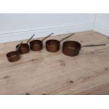 Set of five graduated copper saucepans with wrought iron handles {11 cm H x 27 cm W x 12 cm D to