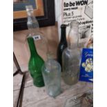 Collection of five various glass drinks bottles. {50 cm H to 30 cm H}.