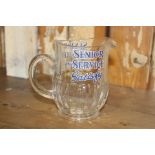 Senior Service Satisfy glass advertising water jug. { 12 cm H x 14 cm W x 8 cm D}.