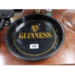 Two Guinness tinplate advertising trays. { 33 dia} and {27 cm Dia}.