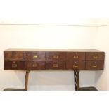 Mahogany bank of ten drawers with brass fittings. {28 cm H x 150 cm W x 39 cm D}.