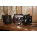 Three box cameras. {16 cm H x 11 cm W x 9 cm D}.