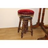 Oak swivel bar stool with red velvet upholstered seat {54 cm H x 34 cm Dia.}.