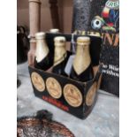 Five bottles of Guinness extra stout St. James Gate Dublin, in cardboard advertising carrier {22cm H