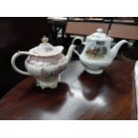 Two ceramic teapots - Hunting scene and Floral decoration {28 cm H and 27 cm H}.