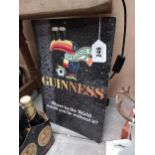 Guinness Where in the world would we be without you? Cardboard advertising sign {38cm H x 26cm W}.