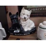 Black and White Scotch whisky ceramic advertising figure. {23 cm H x 29 cm W x 8 cm D}.