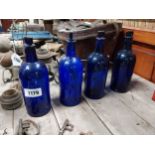 Set of four 19th C. blue glass medicine bottles with original stoppers {23 cm H x 8 cm Dia.}.