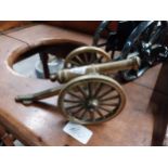 Two models of cannons {15 cm H x 23 cm W x 8 cm D and 8 cm H x 20 cm W x 8 cm D}.