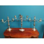 Three silverplate candelabras {42cm H x 33cm W and 38cm H x 35cm W}