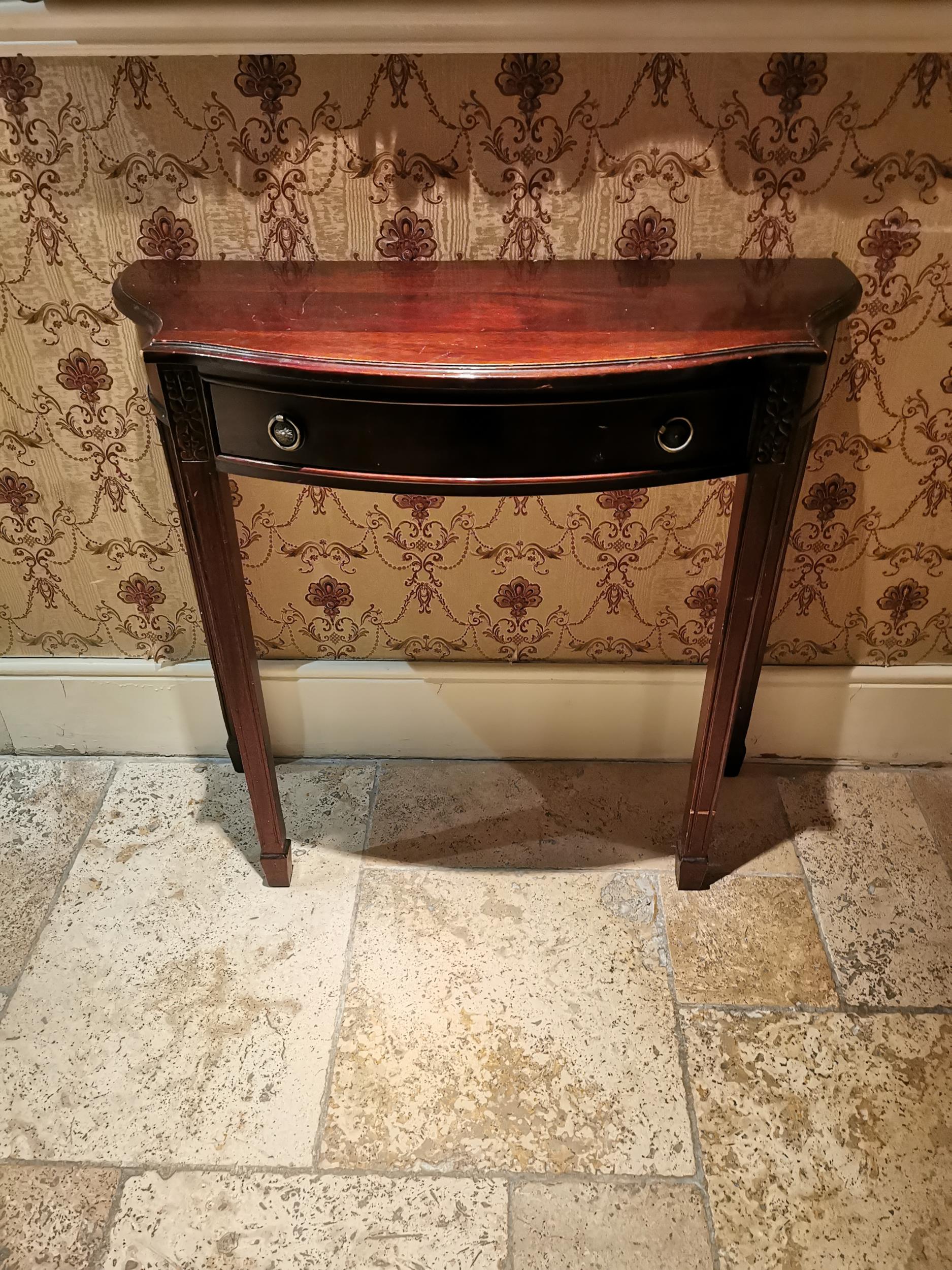 Mahogany consul table, the shaped top above a single drawer in the frieze raised on tapered legs, in