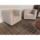 Pair of deep buttoned upholstered mahogany club chairs raised on tapered legs